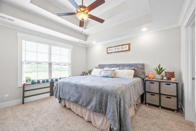 bedroom with ceiling fan, light carpet, ornamental molding, and a raised ceiling