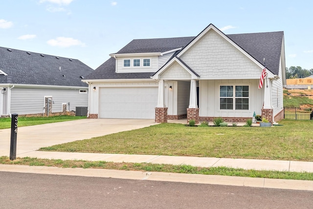 craftsman-style house with a front yard, a garage, a porch, and central air condition unit