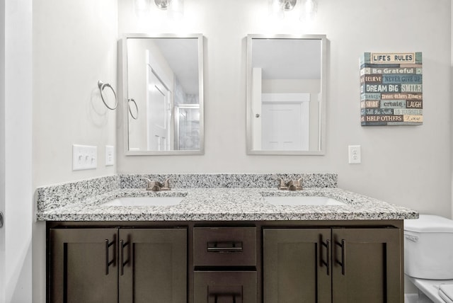 bathroom featuring toilet and vanity