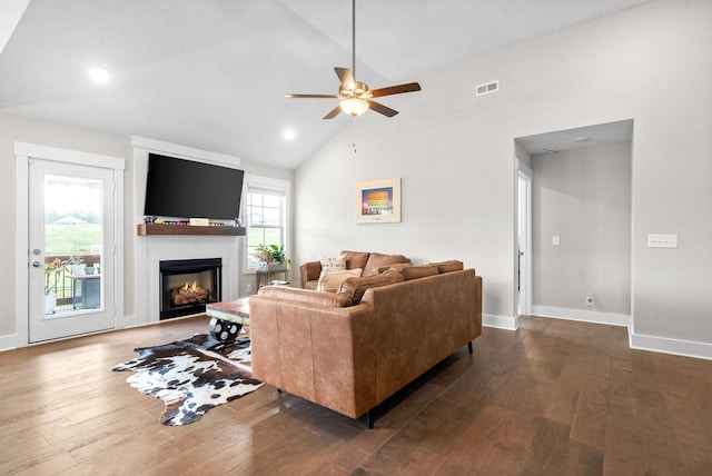 living room featuring ceiling fan, dark hardwood / wood-style floors, a wealth of natural light, and high vaulted ceiling