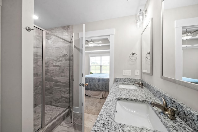 bathroom featuring a shower with shower door, vanity, and ceiling fan