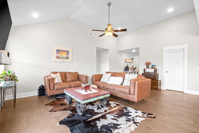 living room featuring ceiling fan, hardwood / wood-style floors, and high vaulted ceiling