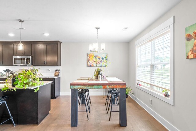 dining area featuring a chandelier and light hardwood / wood-style floors