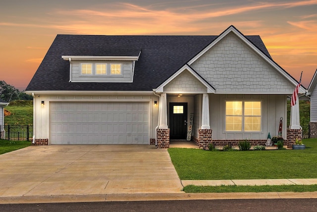 craftsman house featuring a garage and a lawn