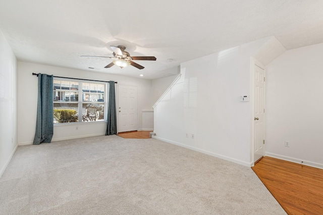 unfurnished room featuring ceiling fan, light carpet, and vaulted ceiling