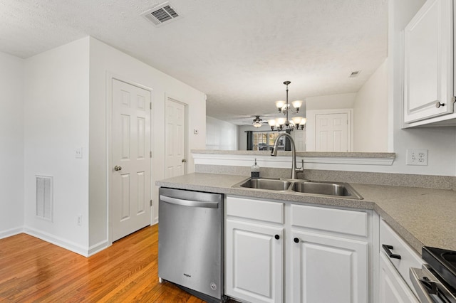 kitchen featuring pendant lighting, ceiling fan with notable chandelier, sink, white cabinetry, and stainless steel appliances