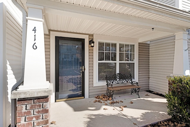 view of exterior entry with a porch