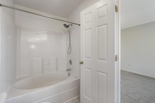 bathroom with shower / bathing tub combination and a textured ceiling