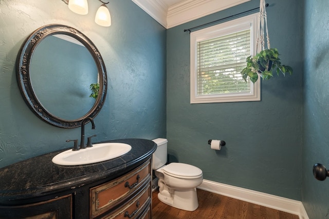 bathroom with hardwood / wood-style flooring, toilet, vanity, and ornamental molding