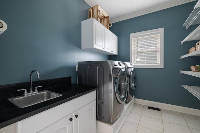 clothes washing area featuring sink, cabinets, washing machine and dryer, light tile patterned floors, and ornamental molding