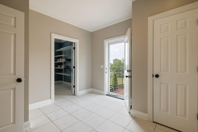 entryway with light tile patterned floors and crown molding