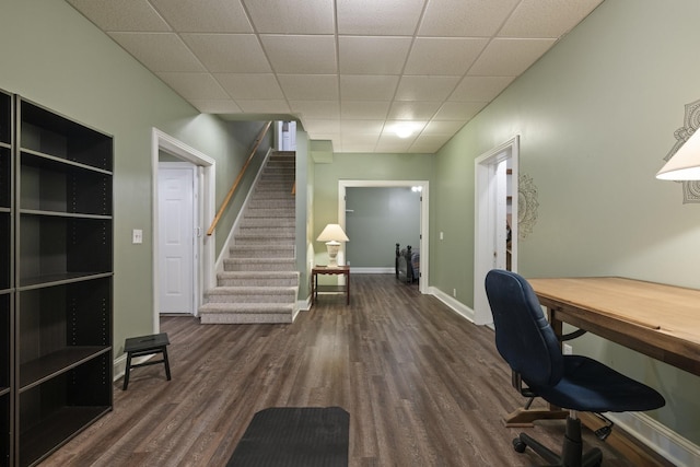 office space with dark hardwood / wood-style flooring and a paneled ceiling