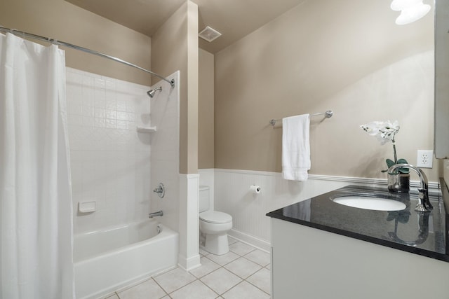 full bathroom featuring tile patterned flooring, vanity, toilet, and shower / bathtub combination with curtain