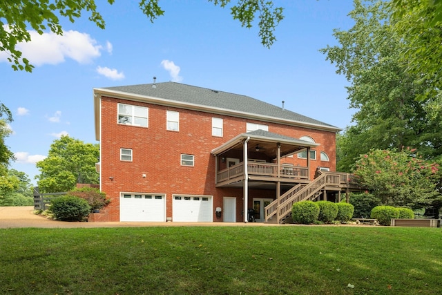 back of property featuring a lawn, ceiling fan, a garage, and a wooden deck