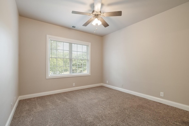 carpeted spare room featuring ceiling fan