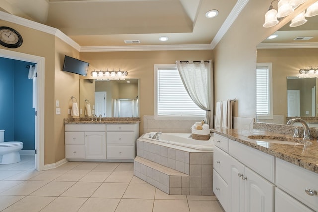 bathroom featuring vanity, tile patterned floors, toilet, ornamental molding, and tiled tub