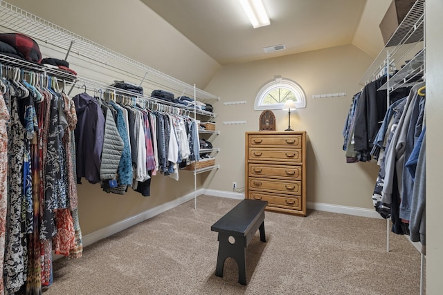 spacious closet with carpet flooring and lofted ceiling