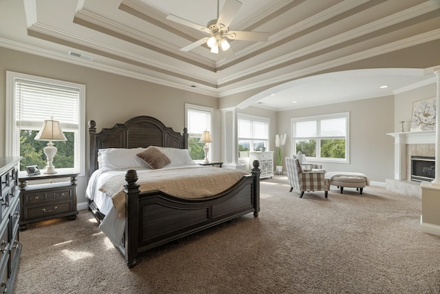 bedroom featuring ceiling fan, dark carpet, a raised ceiling, and crown molding