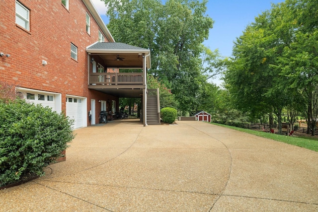 view of patio featuring a wooden deck, ceiling fan, and a garage