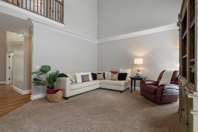 living room with a towering ceiling and carpet floors