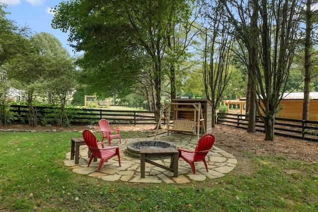 exterior space with an outdoor fire pit and a lawn