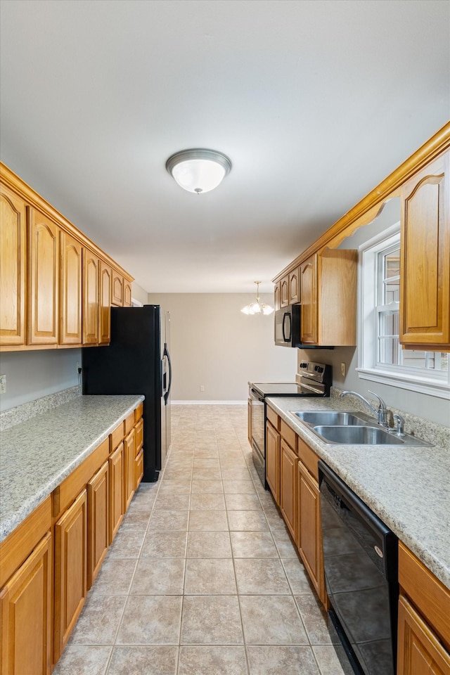 kitchen with pendant lighting, black appliances, sink, light tile patterned flooring, and a chandelier