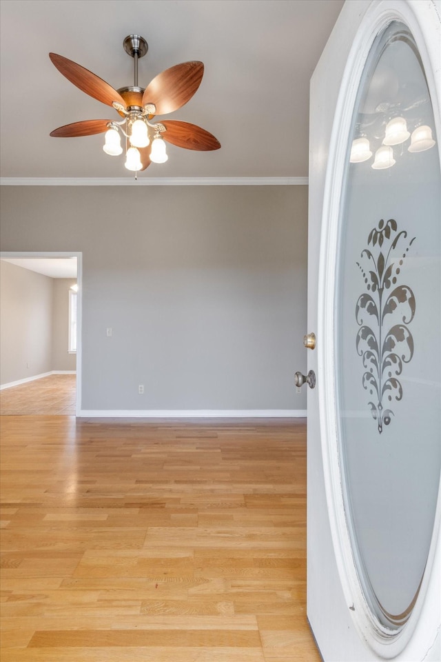 unfurnished room featuring ceiling fan, light hardwood / wood-style floors, and ornamental molding