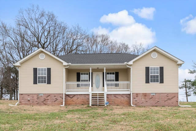 single story home featuring covered porch and a front yard