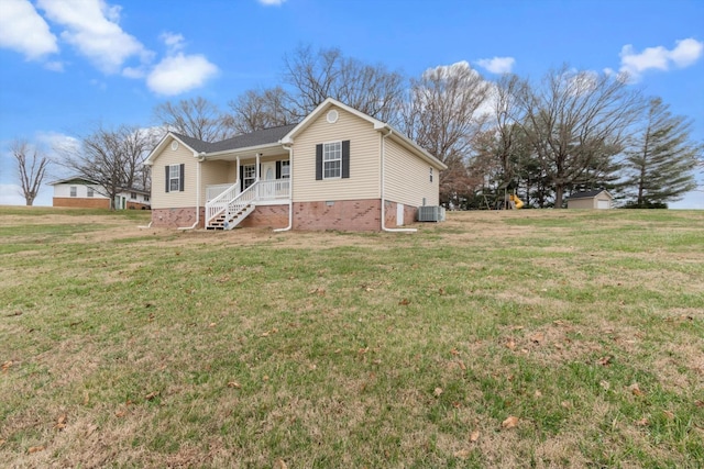 view of front of house featuring a front lawn, central AC unit, and a porch