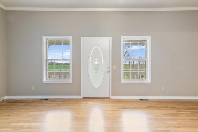 entrance foyer featuring light hardwood / wood-style floors and ornamental molding