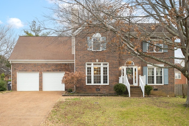 view of front of property featuring a garage and a front lawn