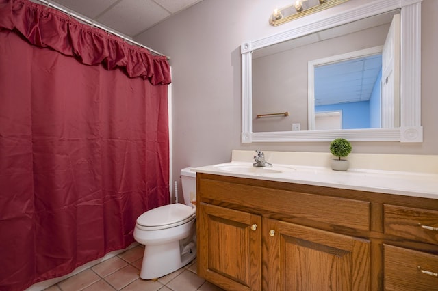 bathroom featuring tile patterned flooring, vanity, toilet, and walk in shower