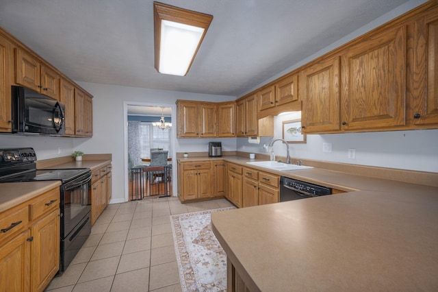 kitchen featuring sink, hanging light fixtures, an inviting chandelier, light tile patterned floors, and black appliances