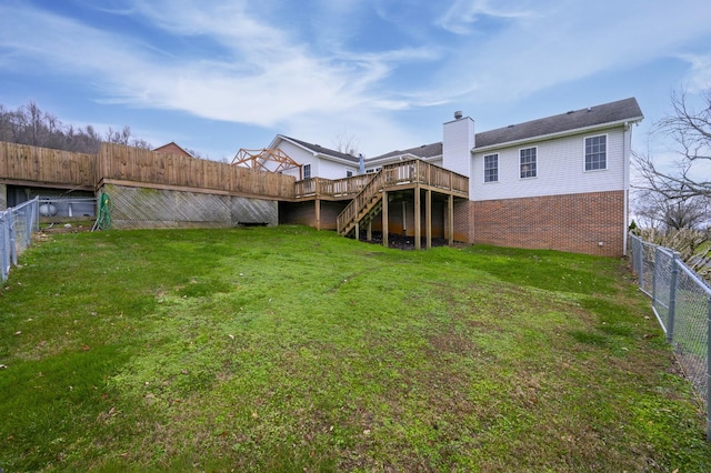 rear view of property featuring a deck and a lawn