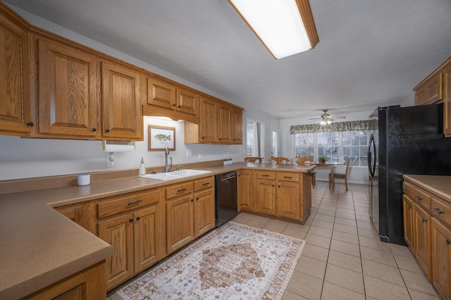 kitchen with kitchen peninsula, ceiling fan, sink, black appliances, and light tile patterned floors