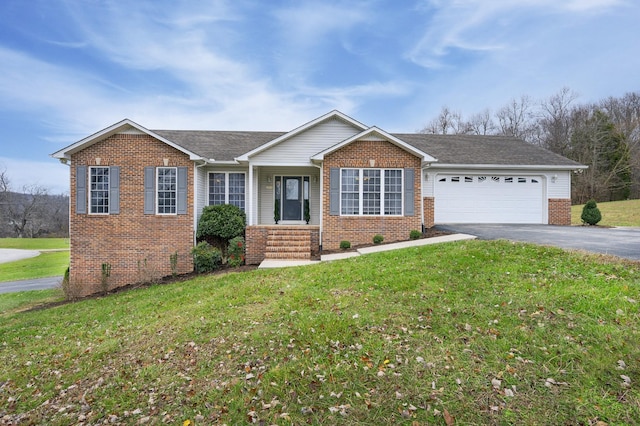 view of front of property with a front yard and a garage