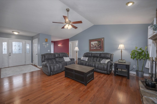 living room with dark hardwood / wood-style floors, ceiling fan, and lofted ceiling