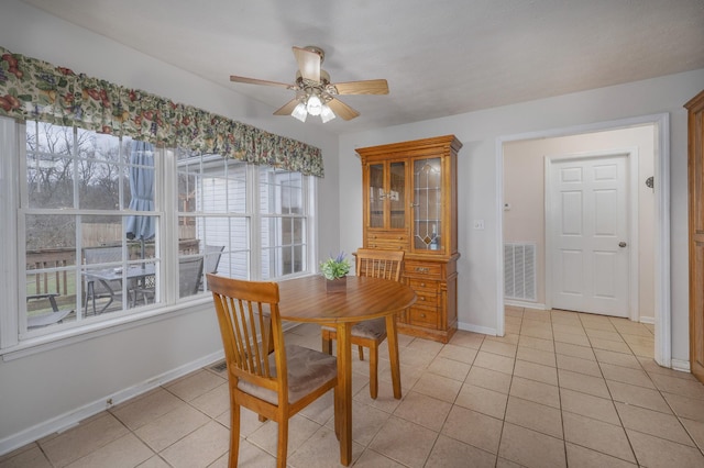 dining area with light tile patterned floors and ceiling fan