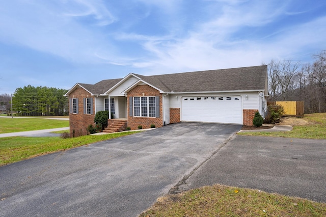 ranch-style house featuring a garage and a front lawn