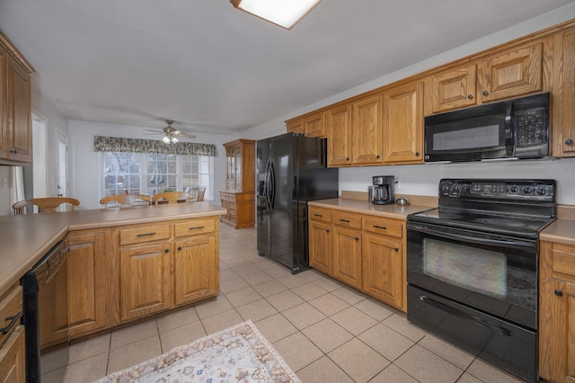 kitchen with black appliances, ceiling fan, light tile patterned floors, and kitchen peninsula