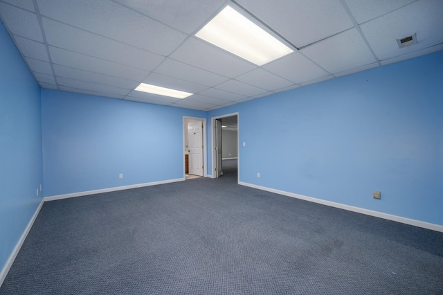 carpeted spare room with a paneled ceiling