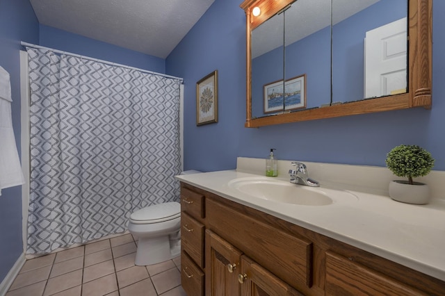 bathroom featuring tile patterned flooring, vanity, a textured ceiling, and toilet