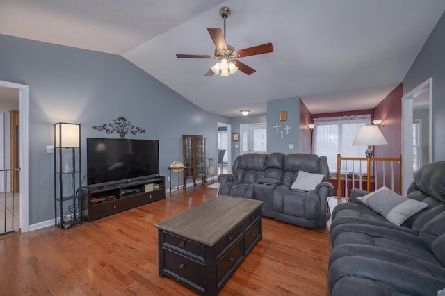 living room featuring hardwood / wood-style floors, ceiling fan, and vaulted ceiling