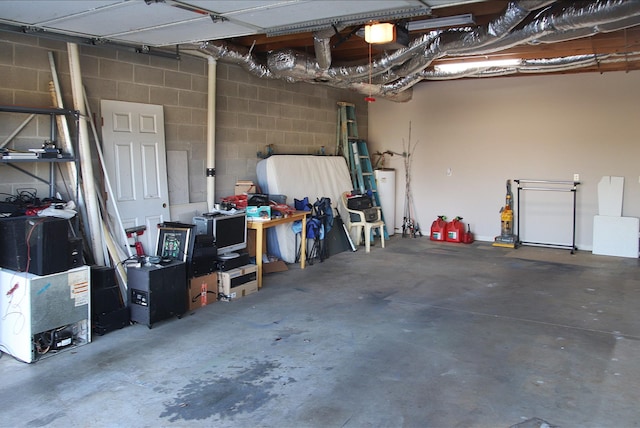 garage with a garage door opener and water heater