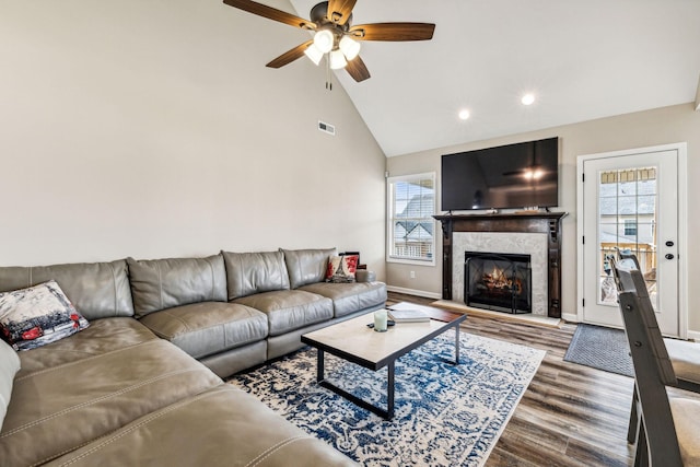 living room with a fireplace, hardwood / wood-style flooring, plenty of natural light, and ceiling fan