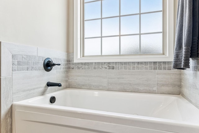 bathroom featuring a bathtub and plenty of natural light