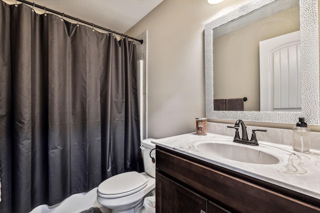 bathroom featuring vanity, curtained shower, and toilet