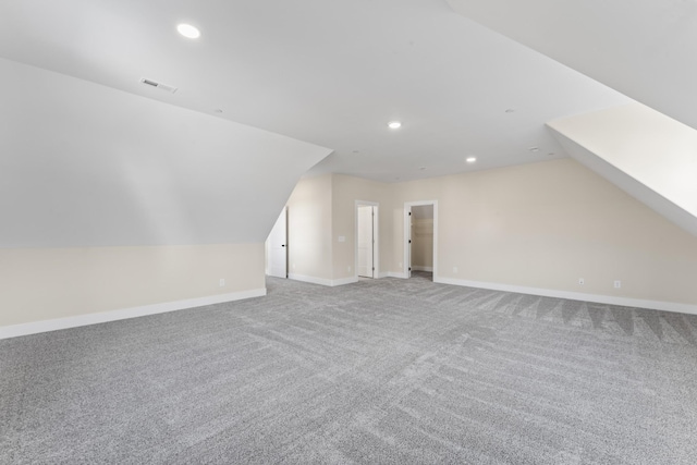 additional living space featuring carpet floors and lofted ceiling