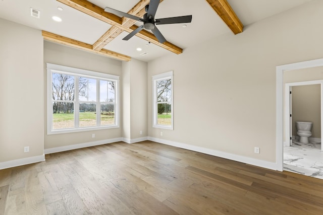 spare room featuring beam ceiling, ceiling fan, and hardwood / wood-style flooring