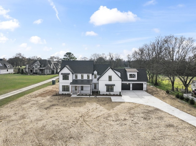 view of front of property featuring a front lawn and a garage